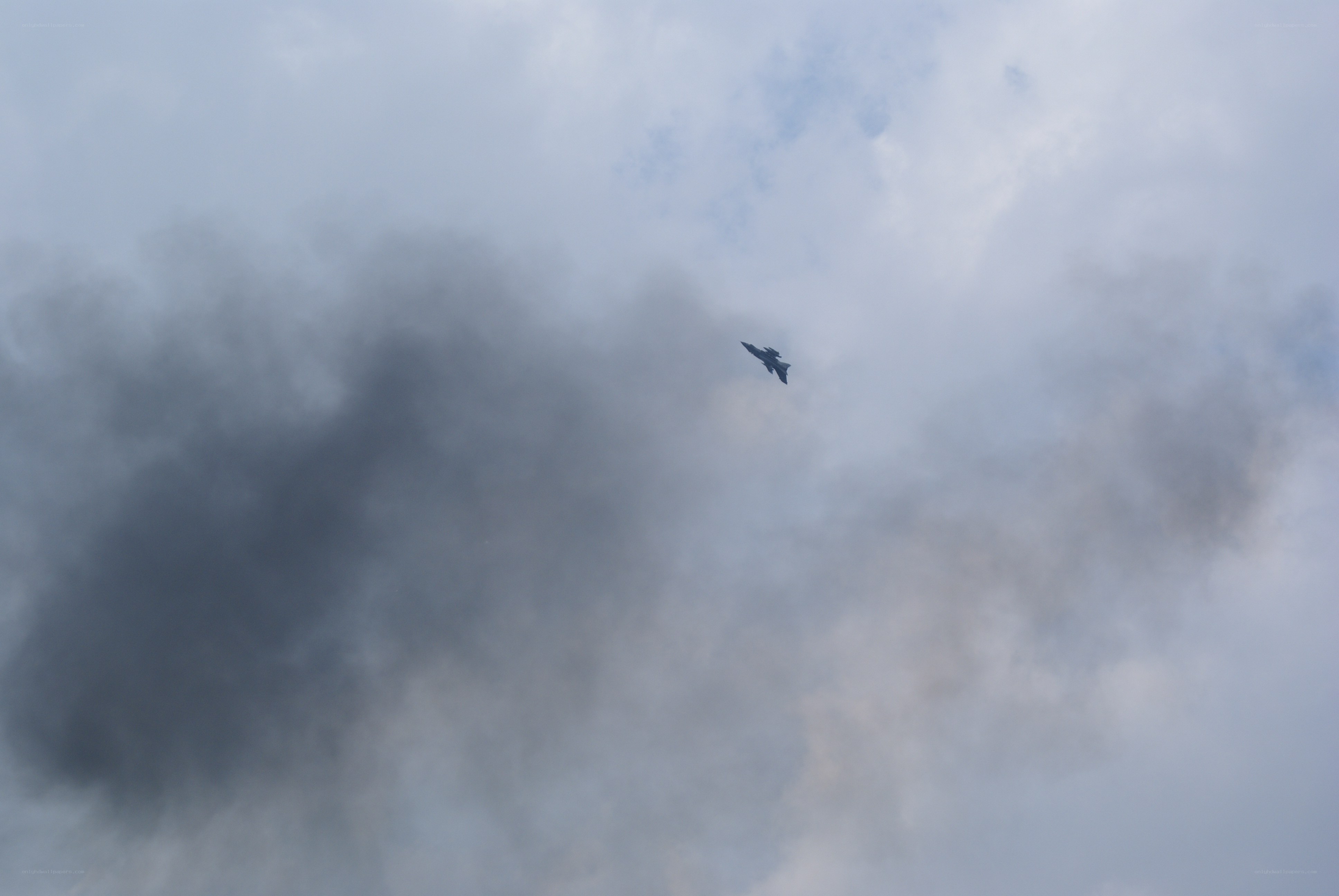 Jet flying through cloudy sky