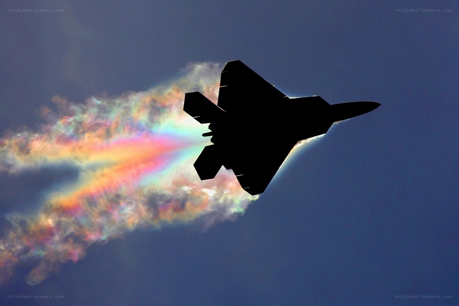 Jet flying with rainbow contrail
