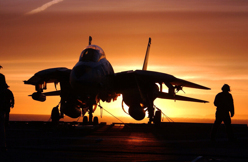 Jet on aircraft carrier at sunset