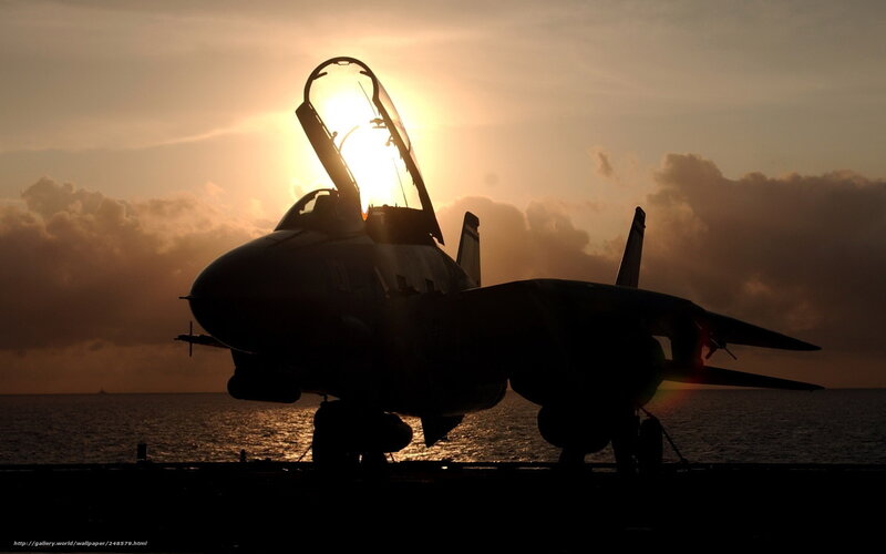 Jet on aircraft carrier at sunset