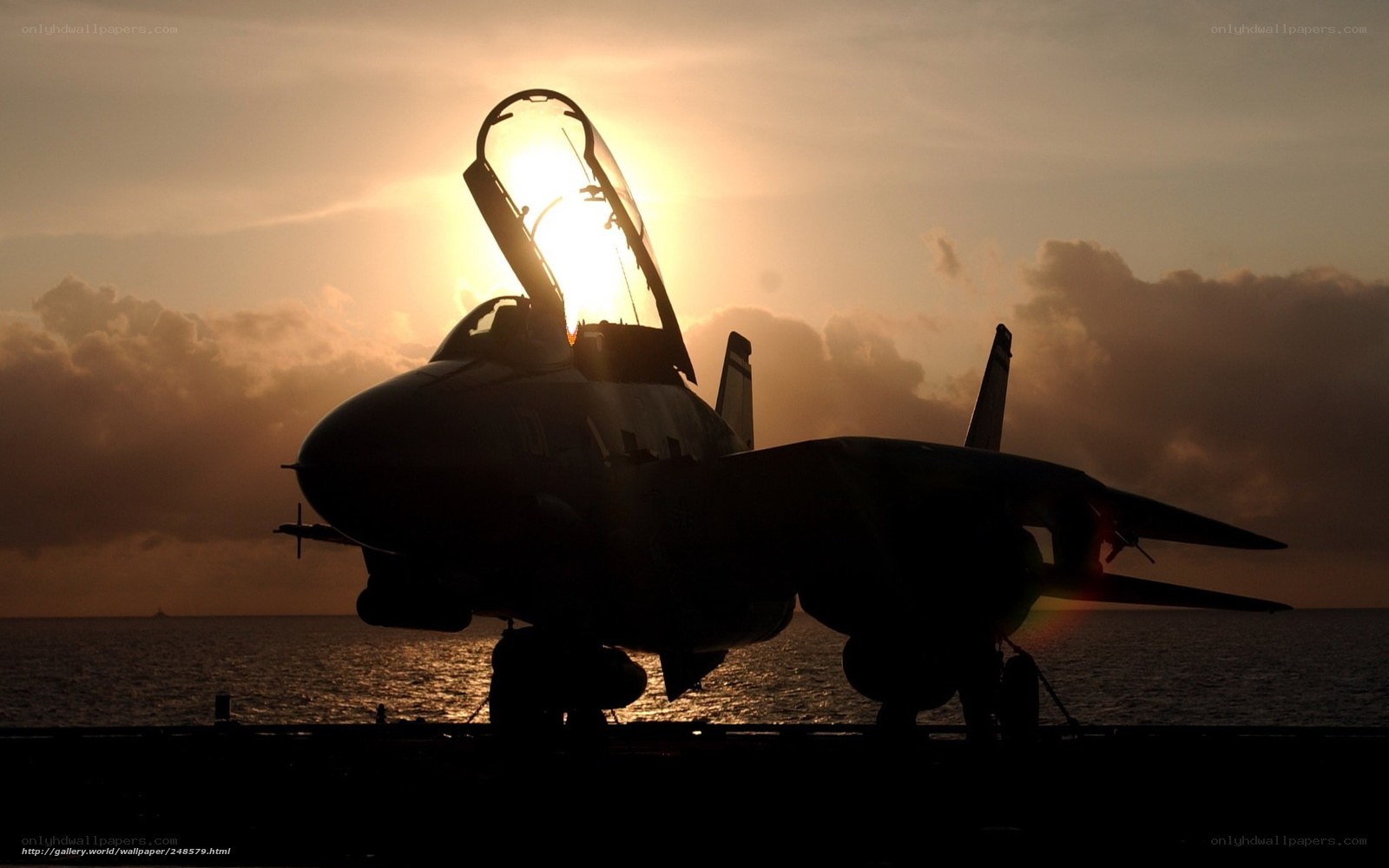 Jet on aircraft carrier at sunset
