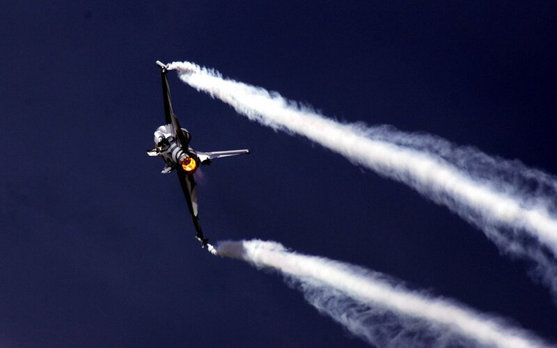 Jet performing aerobatic maneuver