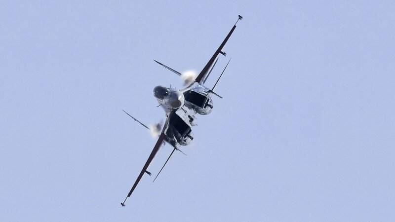 Jet performing aerobatic maneuver
