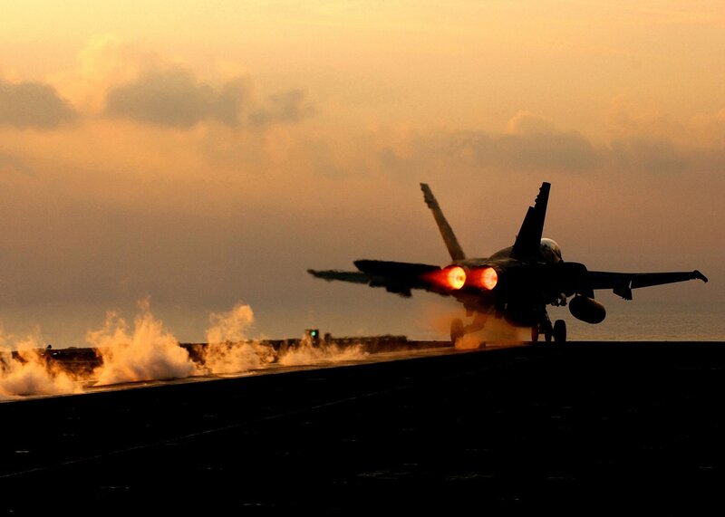 Jet taking off at sunset