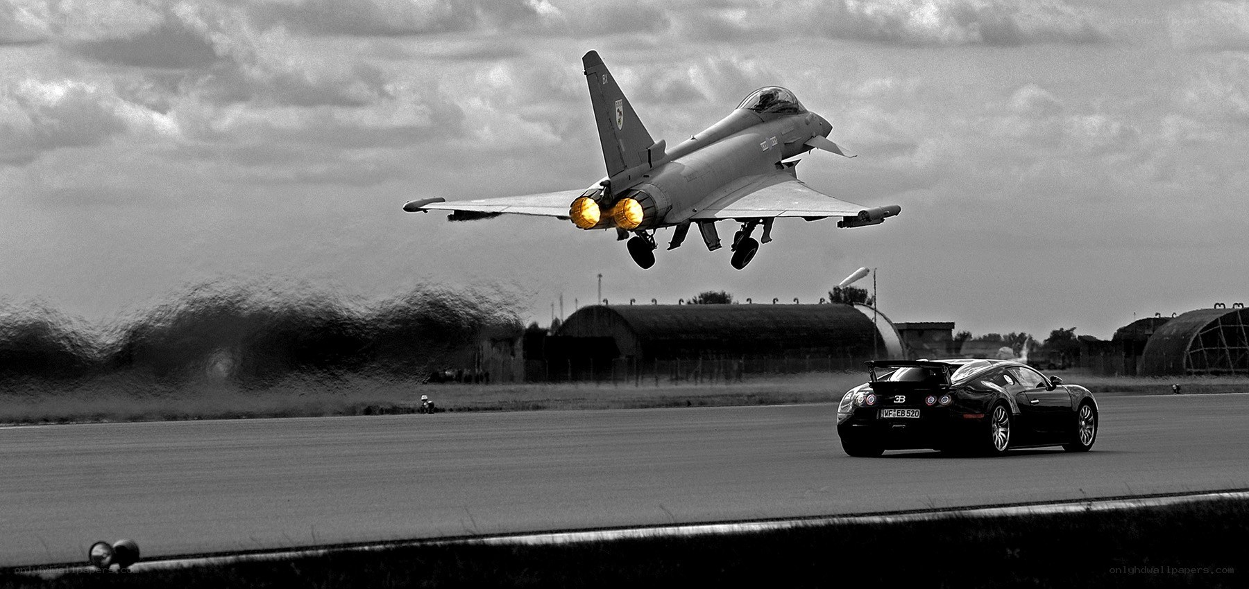 Jet taking off beside a car