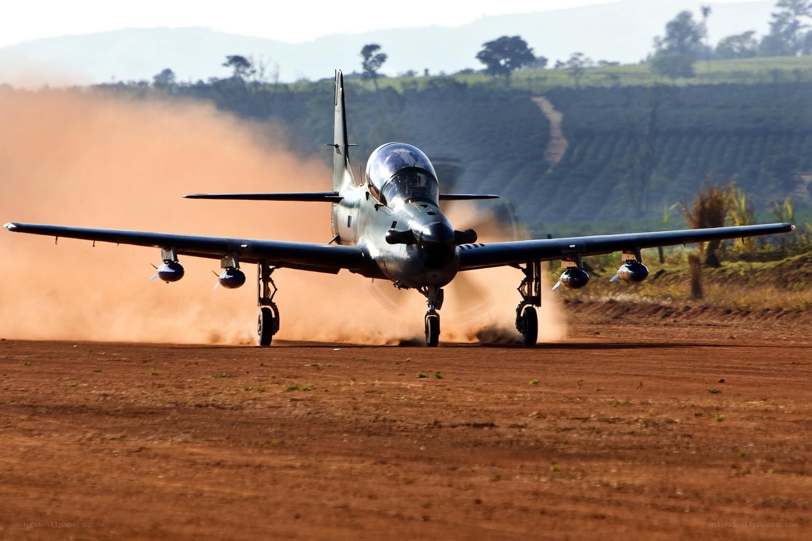 Jet taking off from dirt runway