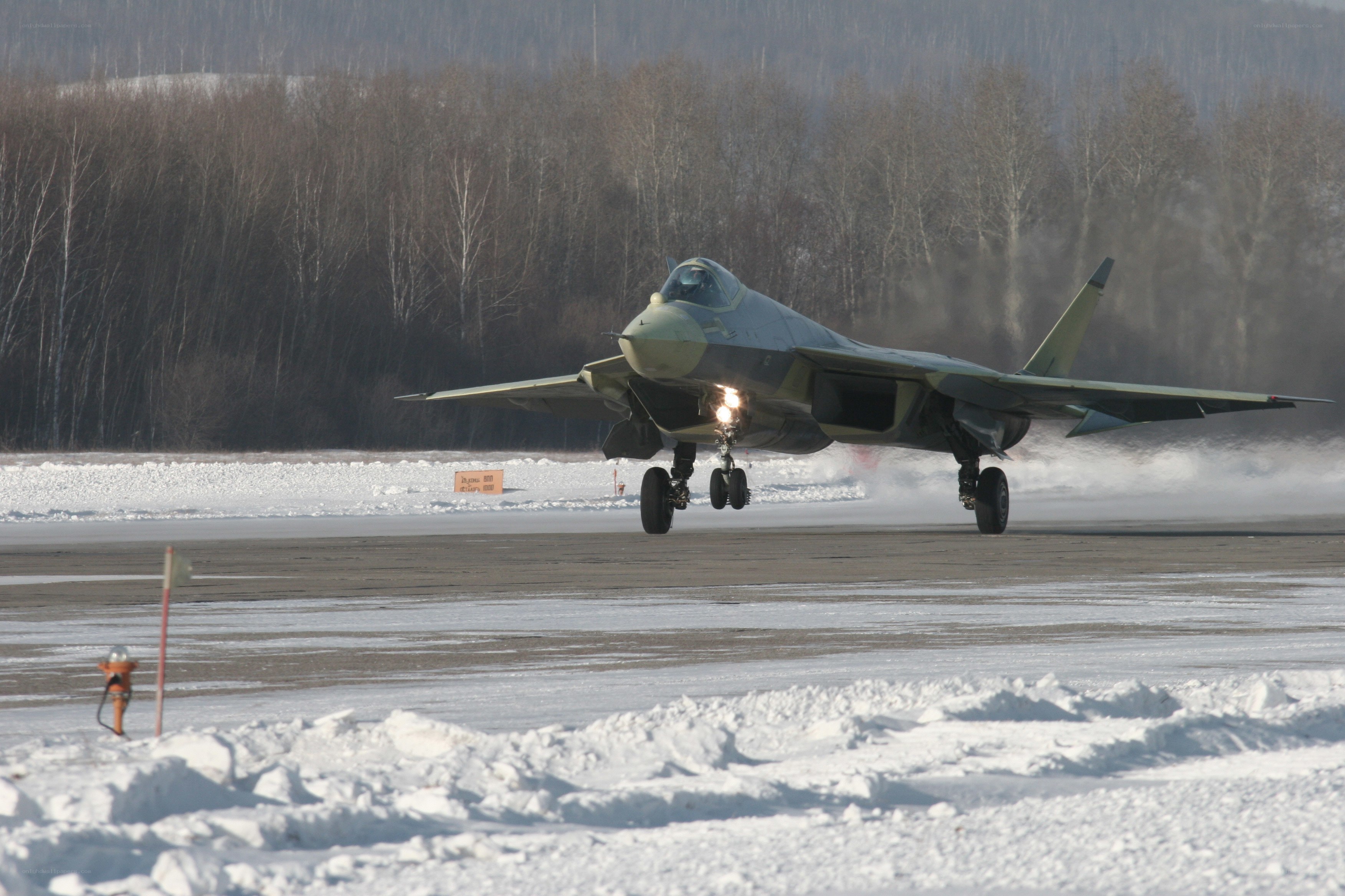 Jet taking off on snowy runway