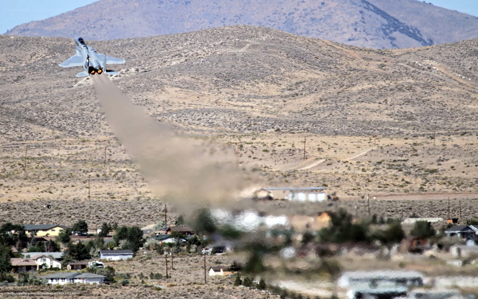 Jet taking off over desert