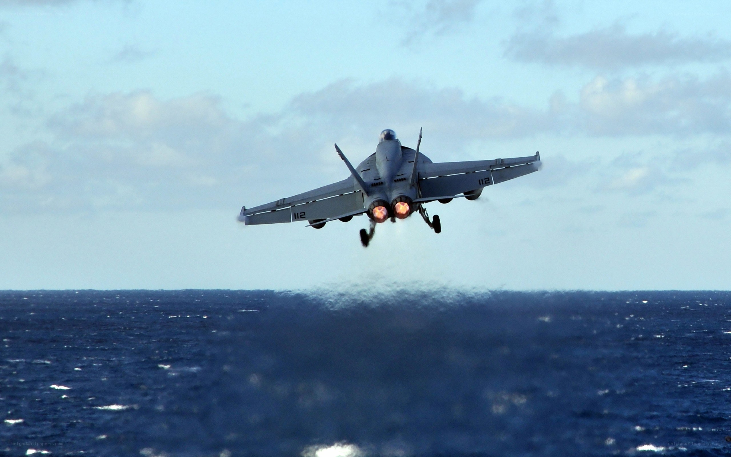 Jet taking off over ocean