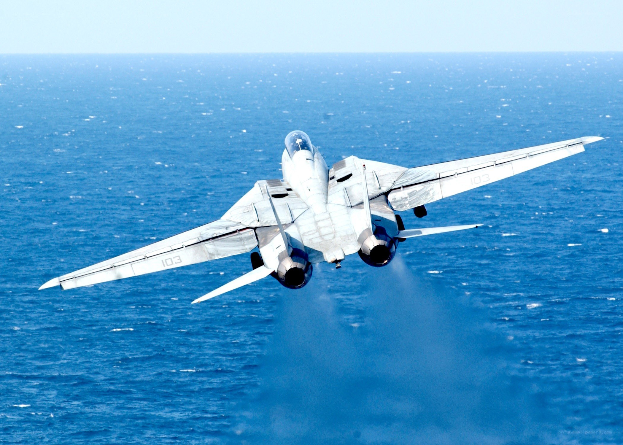 Jet taking off over the ocean