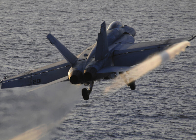 Jet taking off over water