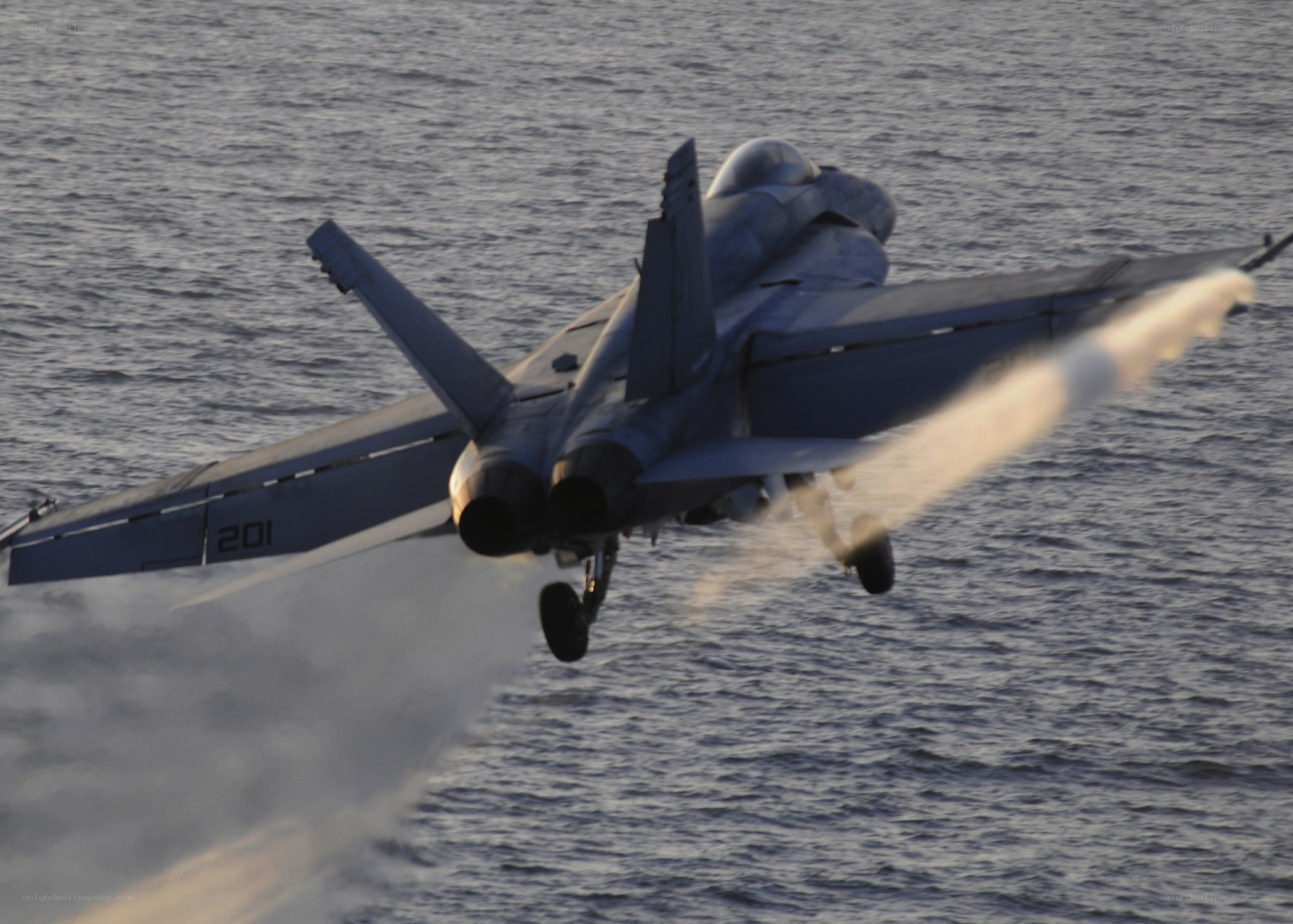 Jet taking off over water