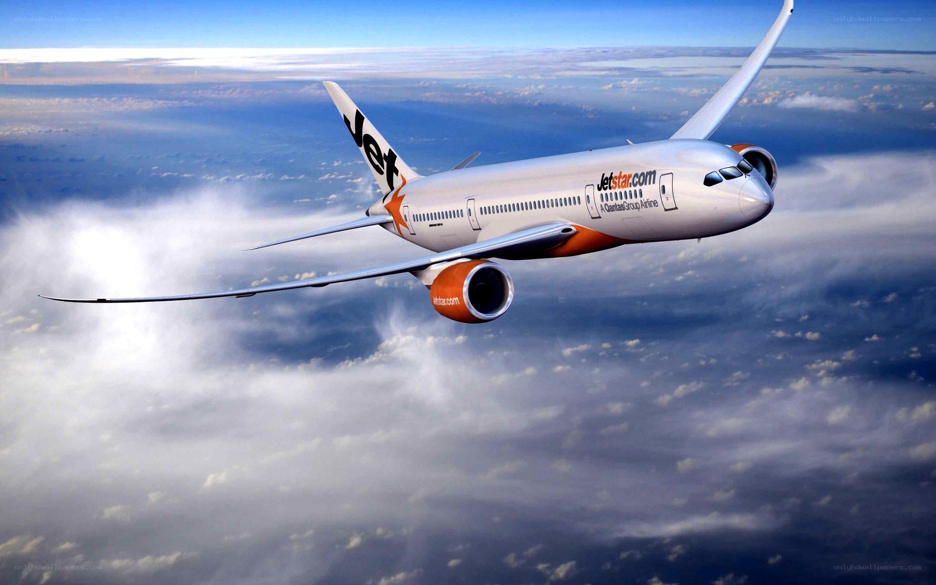 Jetstar airplane flying above clouds