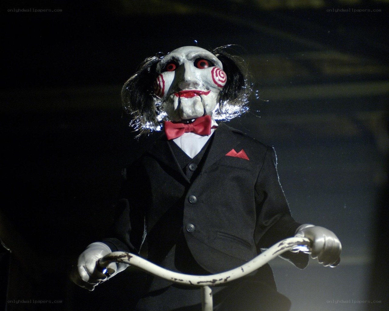 Jigsaw puppet on bicycle