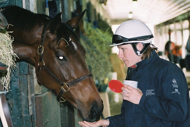 Jockey Feeding Horse