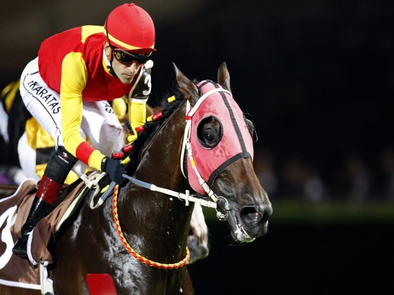 Jockey riding horse at night