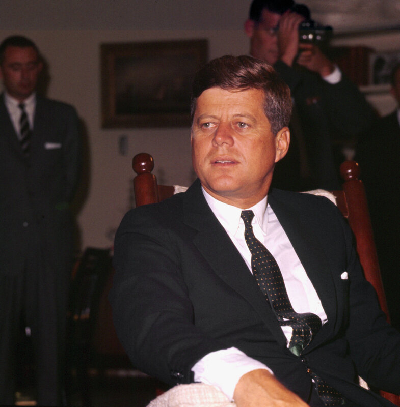 John F Kennedy seated in chair