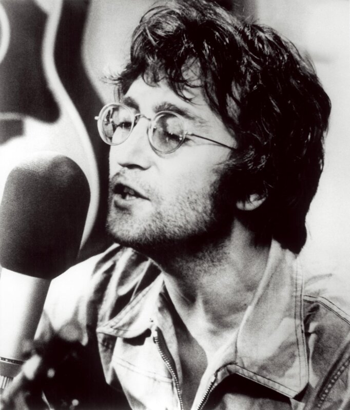 John Lennon singing into microphone