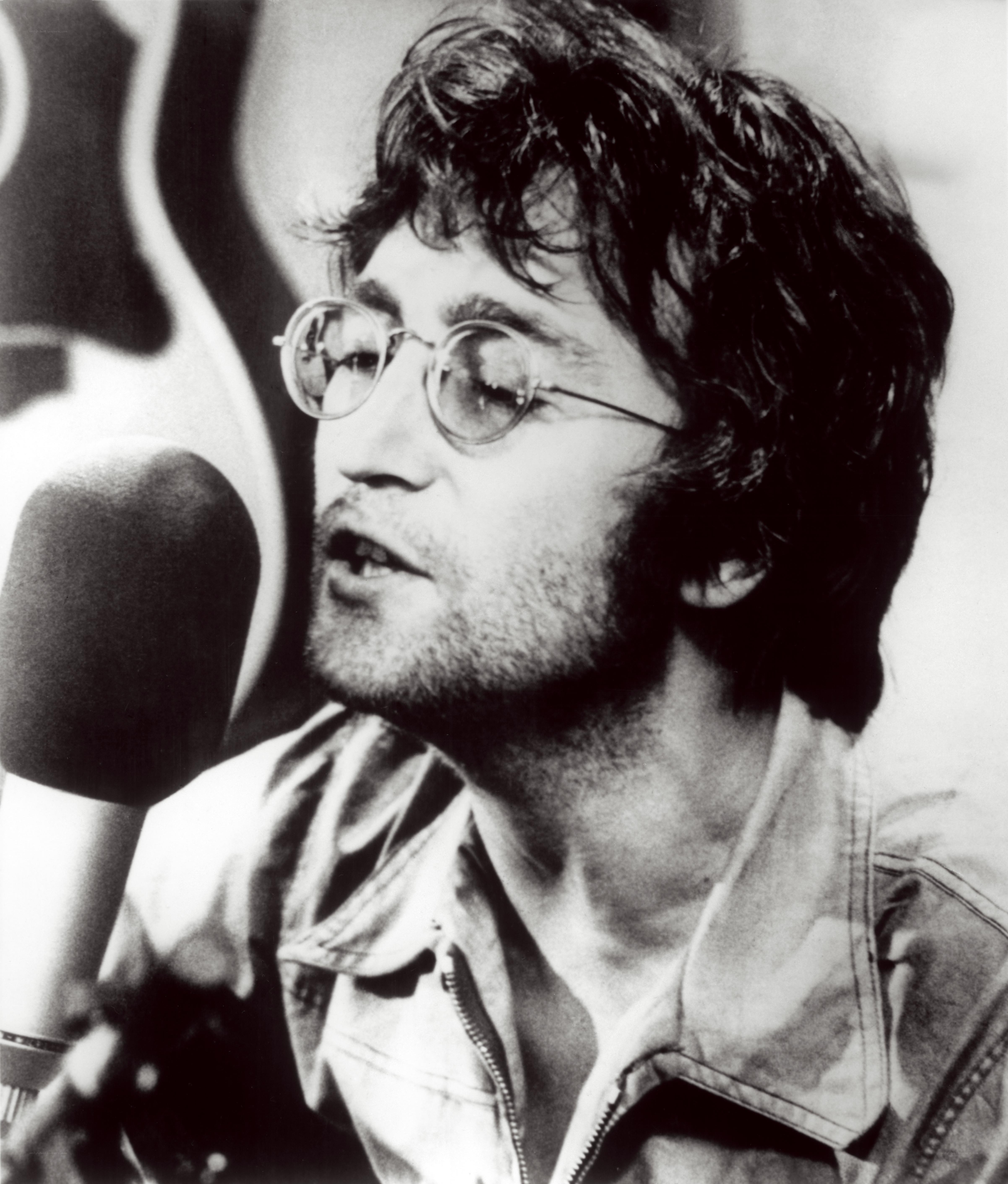 John Lennon singing into microphone