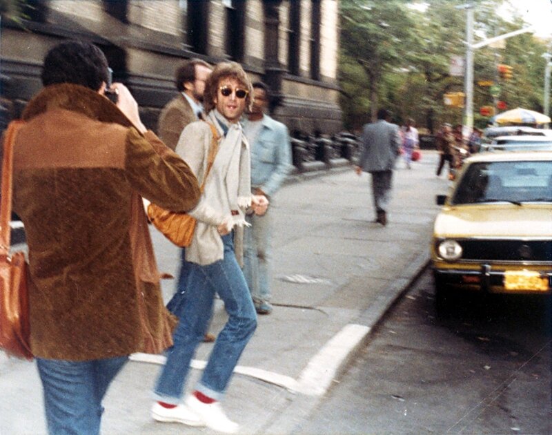 John Lennon walking on a city street