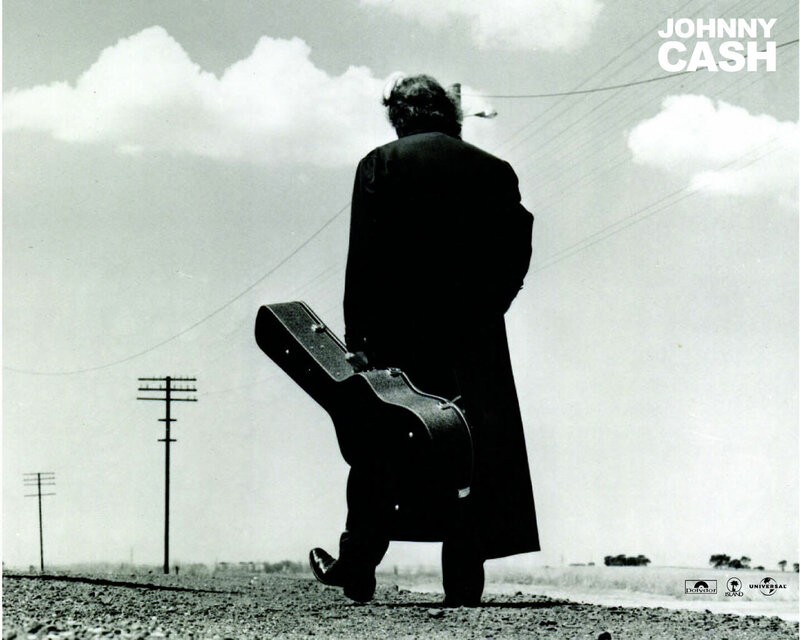 Johnny Cash walking with guitar case