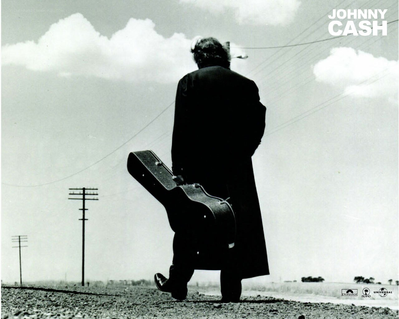Johnny Cash walking with guitar case