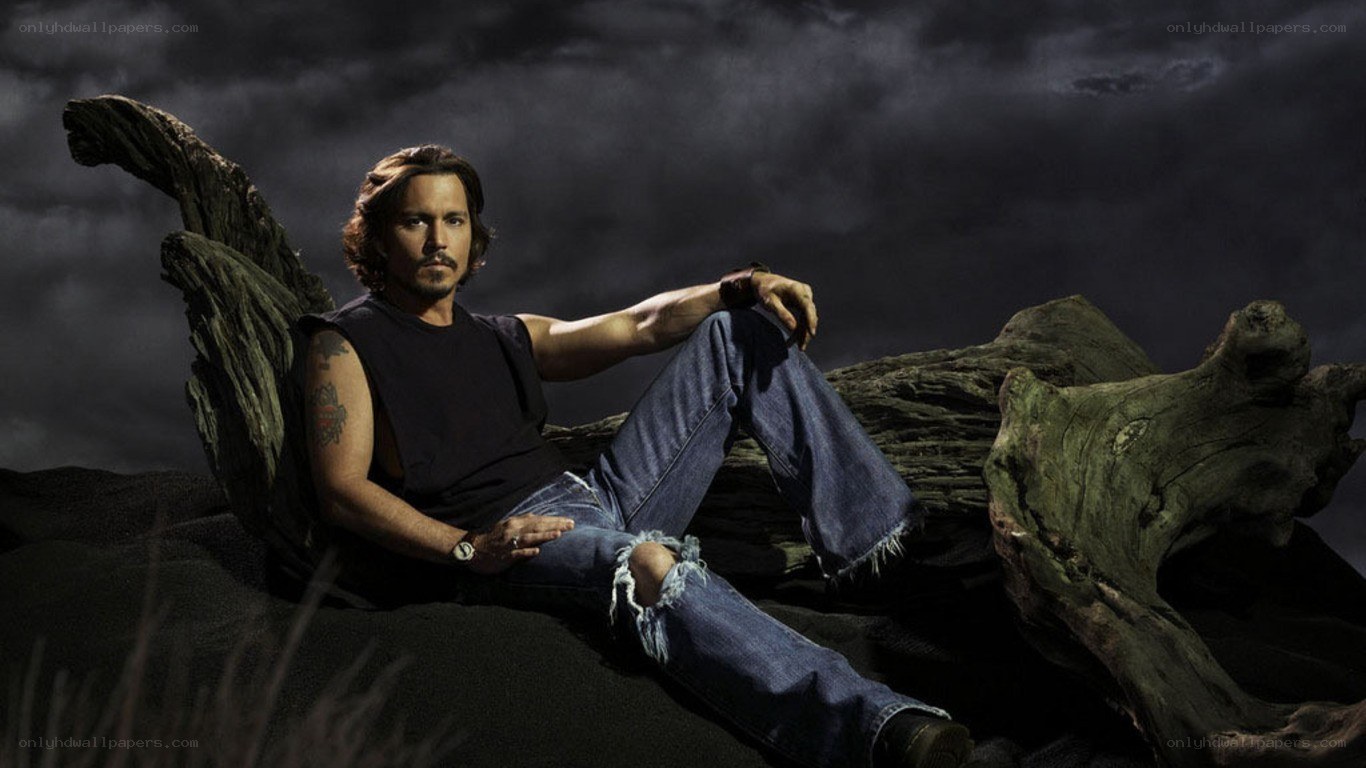 Johnny Depp sitting on driftwood