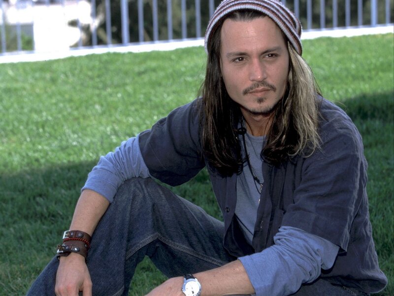 Johnny Depp sitting on grass