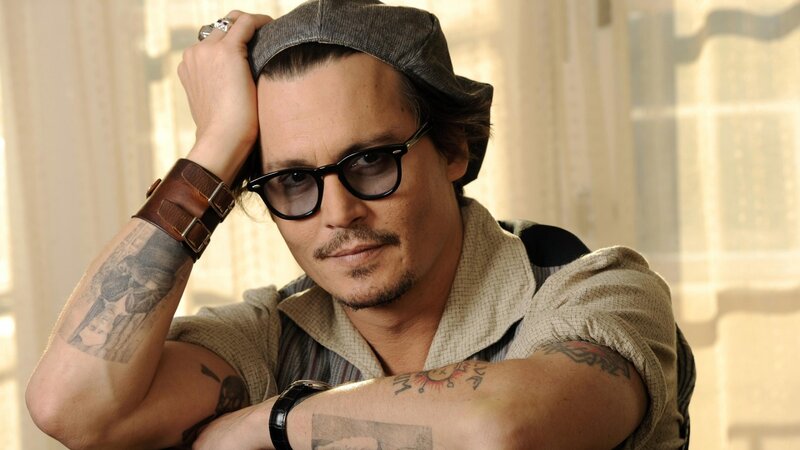 Johnny Depp with tattoos and glasses