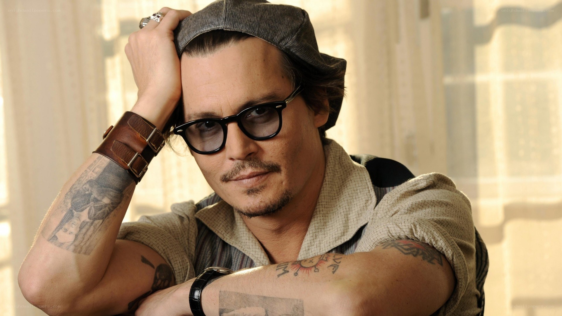 Johnny Depp with tattoos and glasses