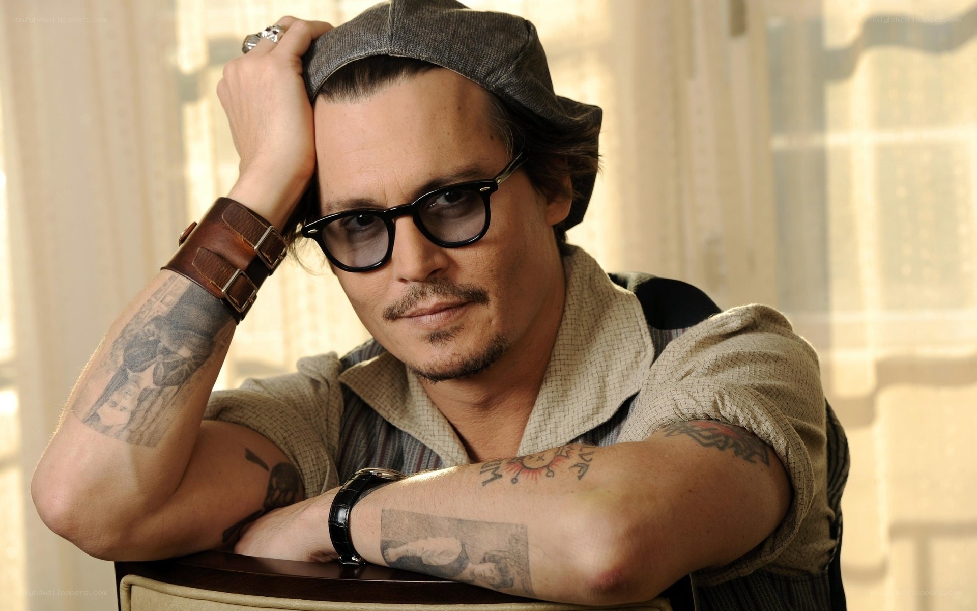 Johnny Depp with tattoos and glasses