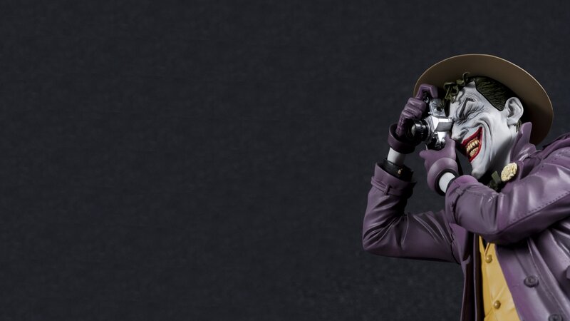 Joker Figurine Holding Camera