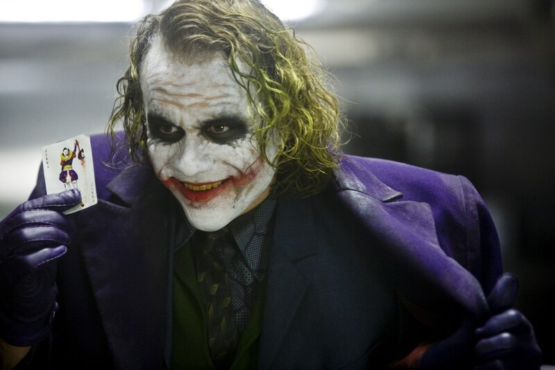 Joker Holding Card — Purple, Dramatic, Photograph