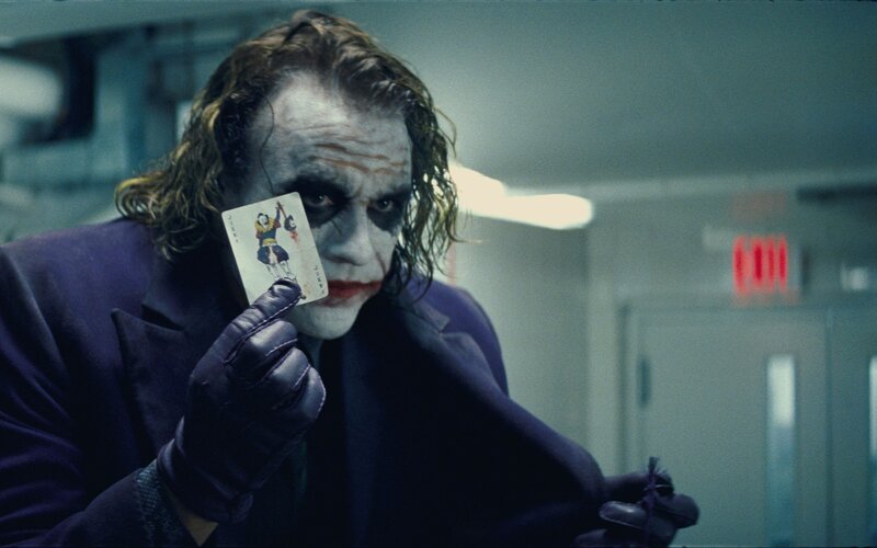 Joker Holding Card — Purple, Dramatic