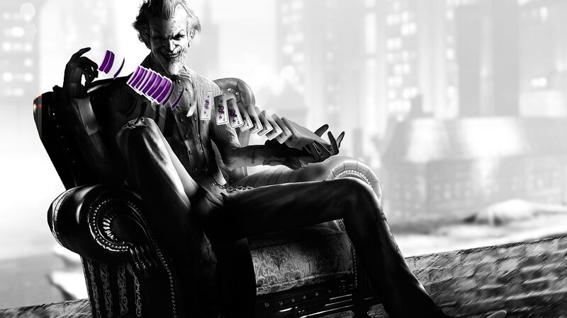Joker holding cards in chair