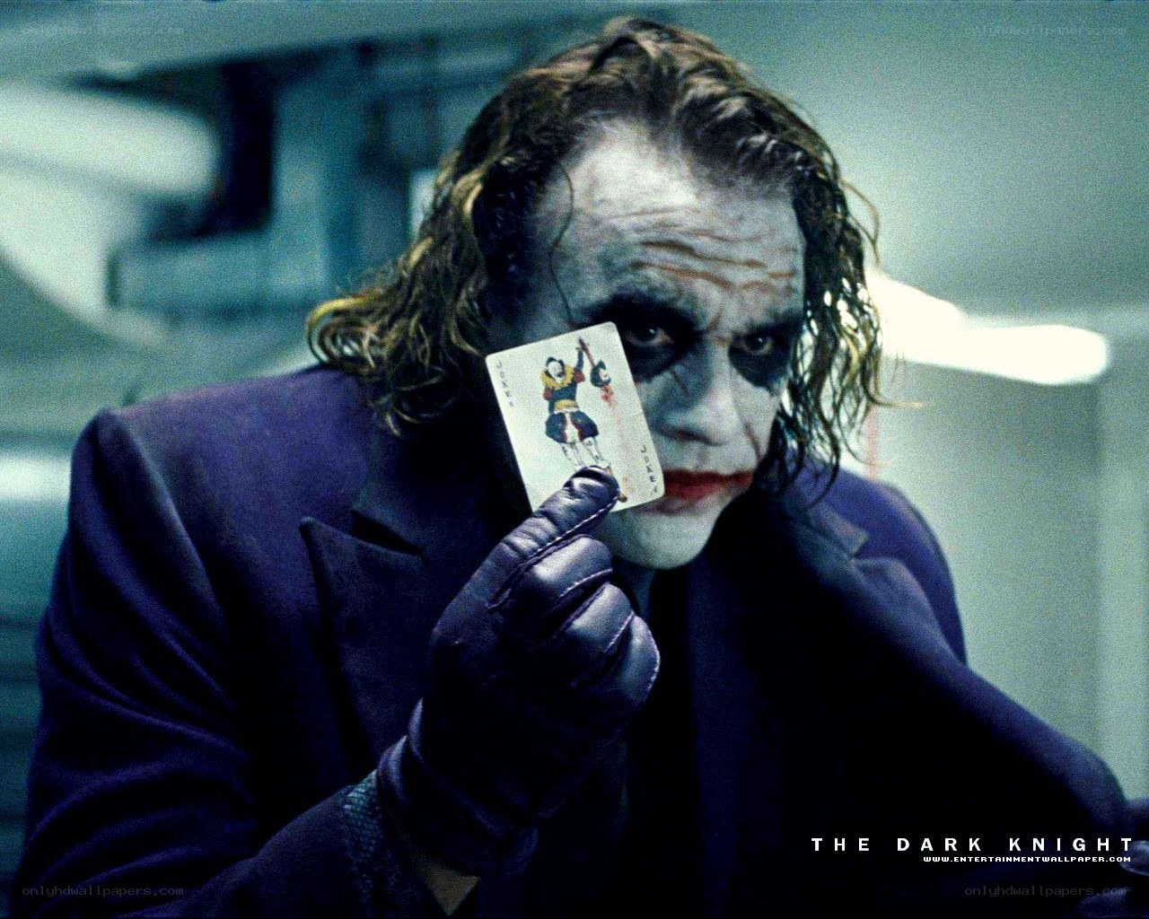 Joker holding playing card