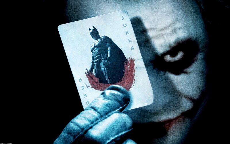 Joker Holding Playing Card — Black, Dramatic