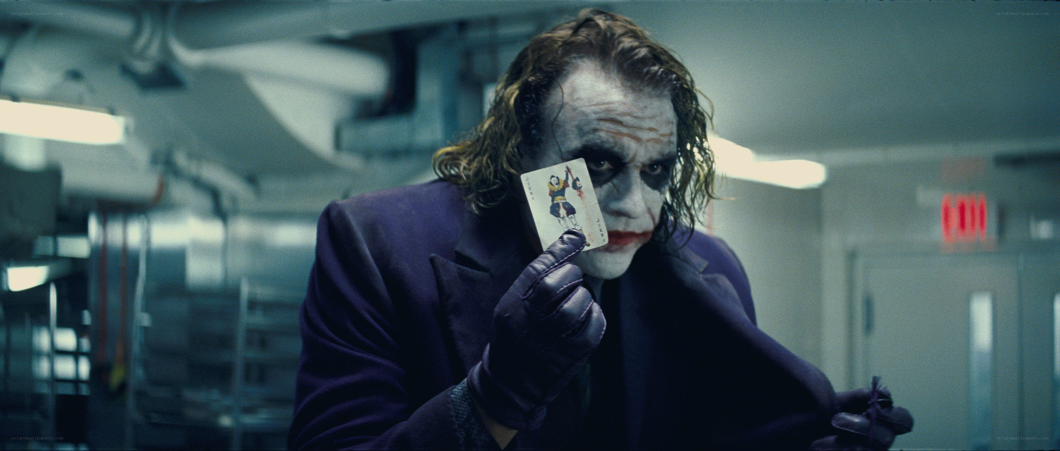 Joker holding playing card