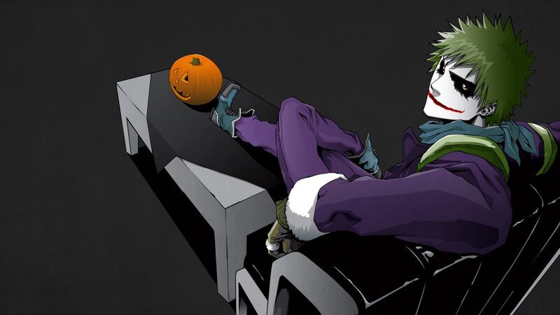 Joker with pumpkin on table