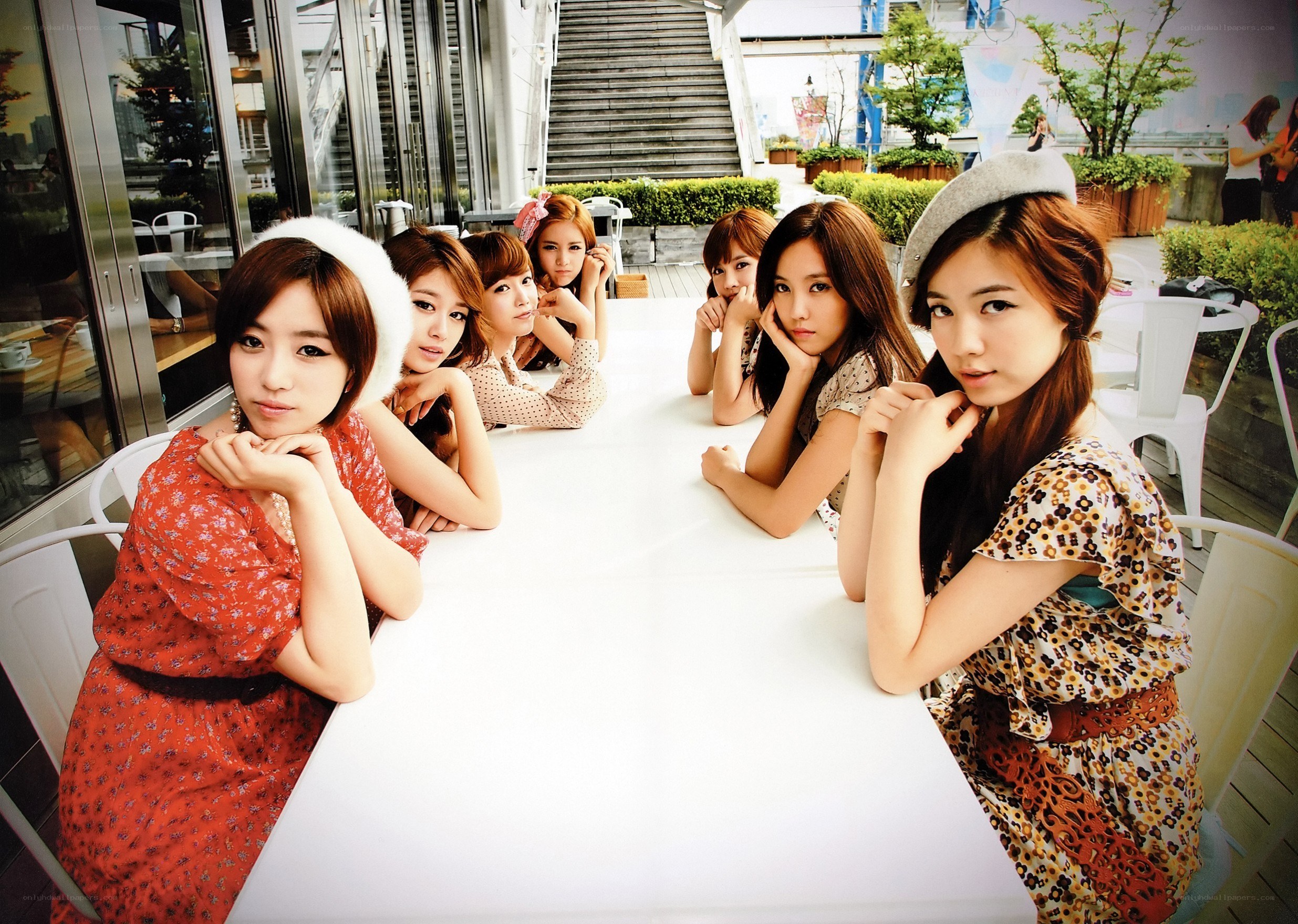 K-pop group at outdoor table