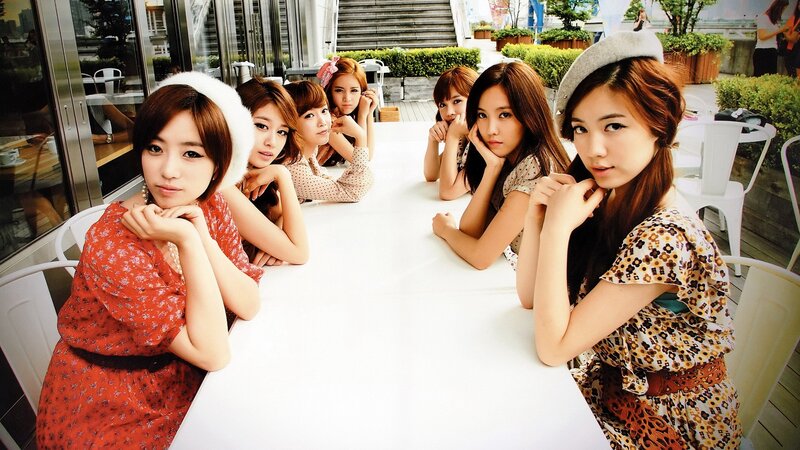 K-pop group at outdoor table