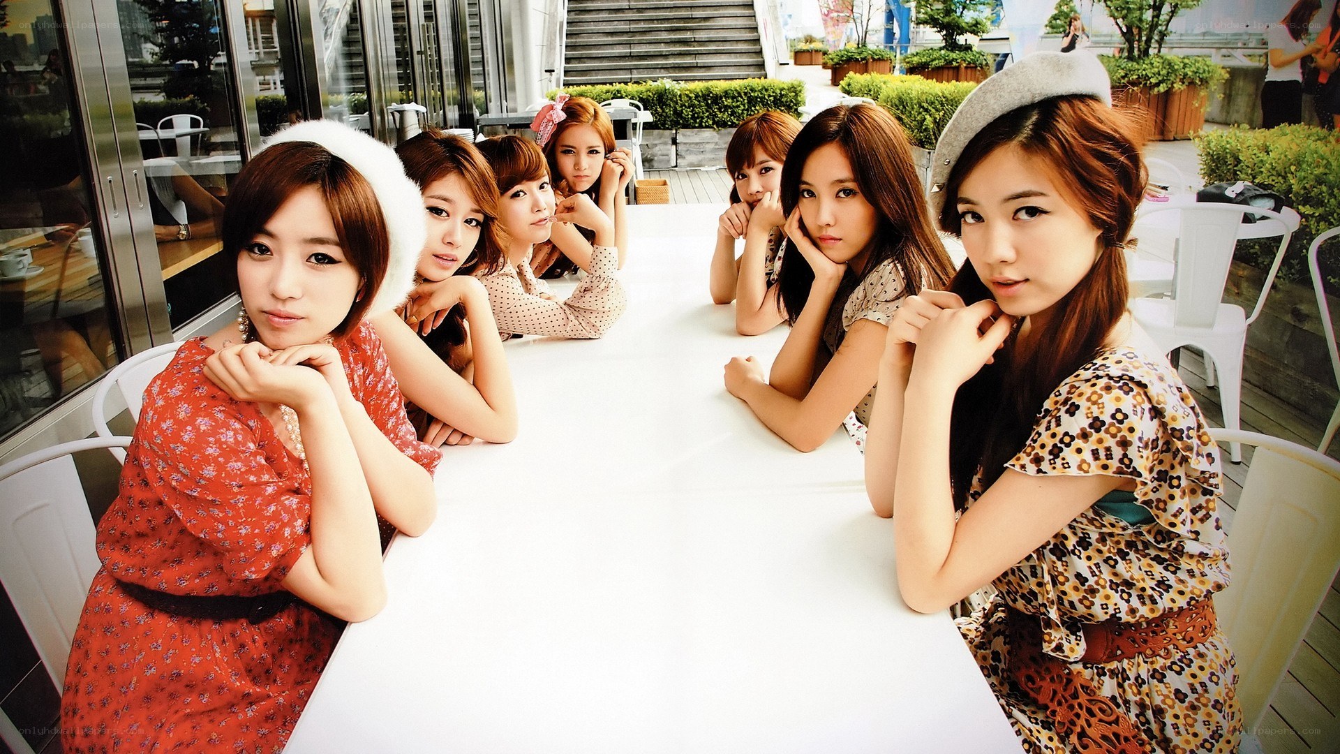 K-pop group at outdoor table