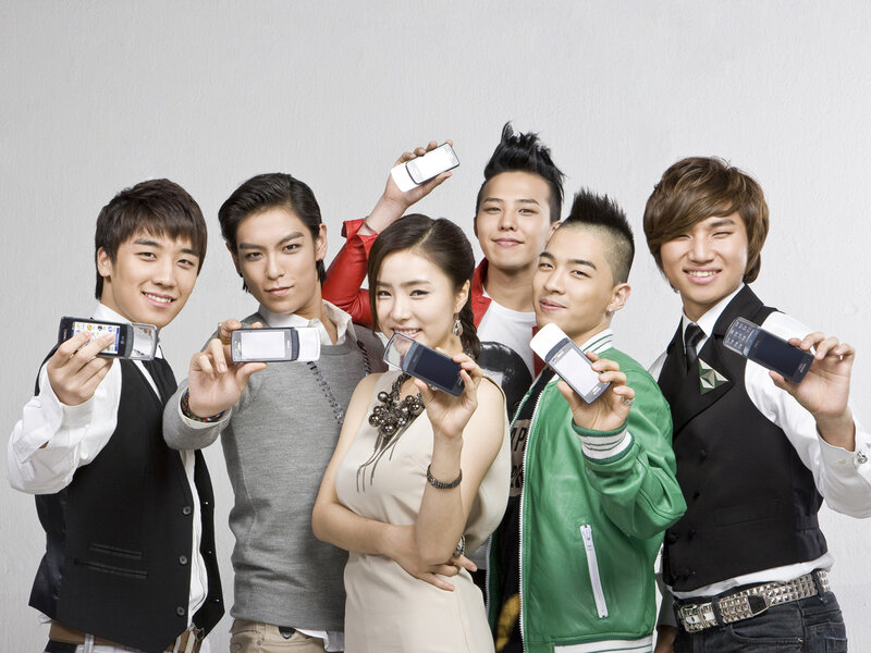 K-pop group holding phones