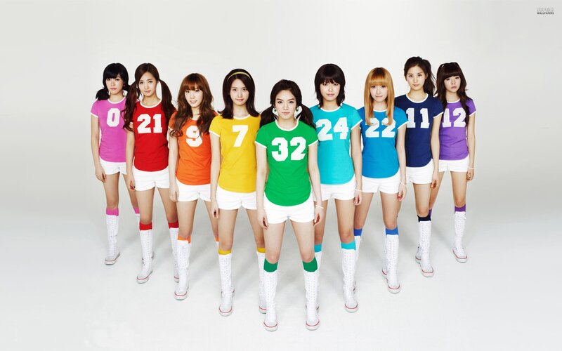 K-pop group in colorful jerseys