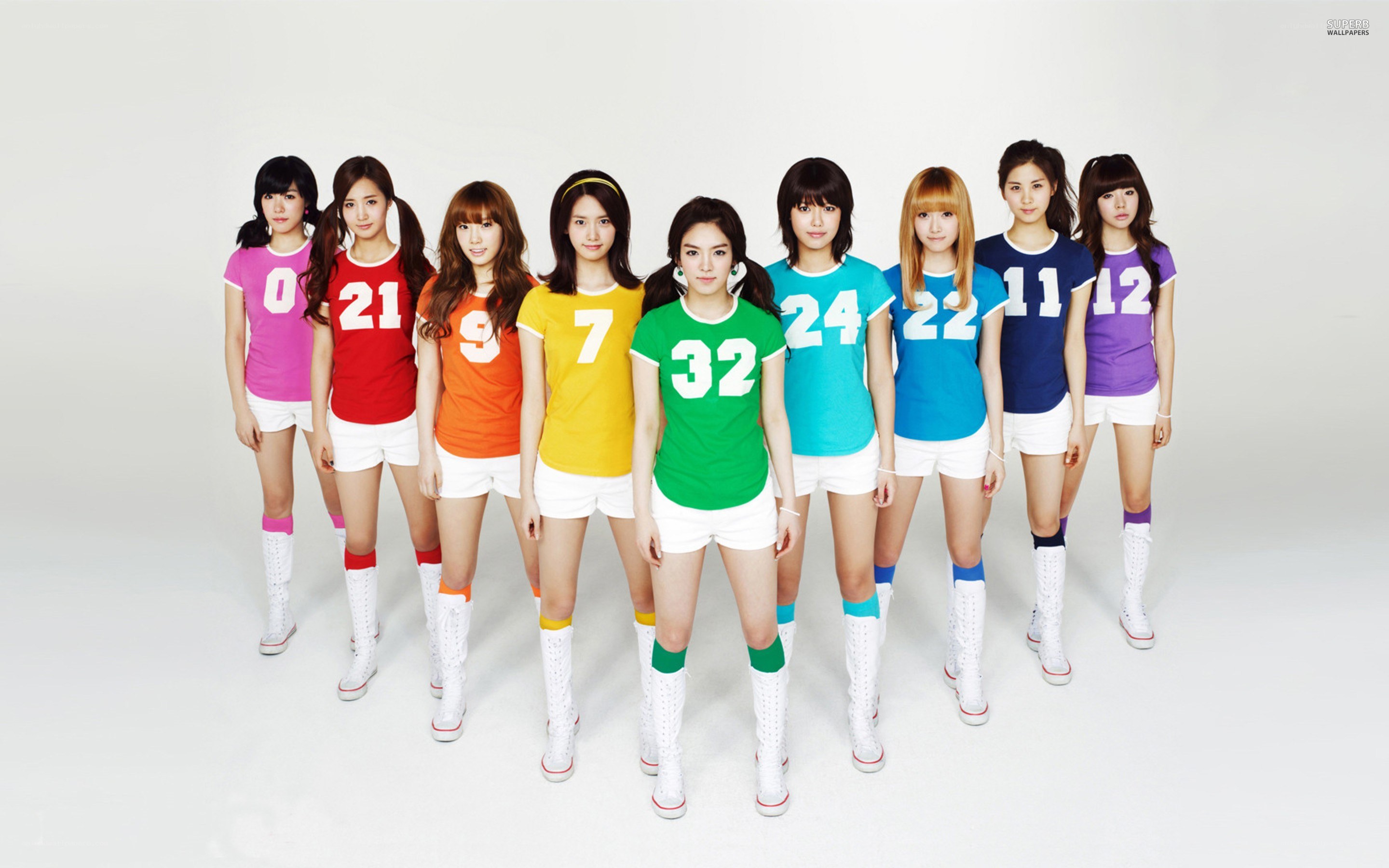 K-pop group in colorful jerseys