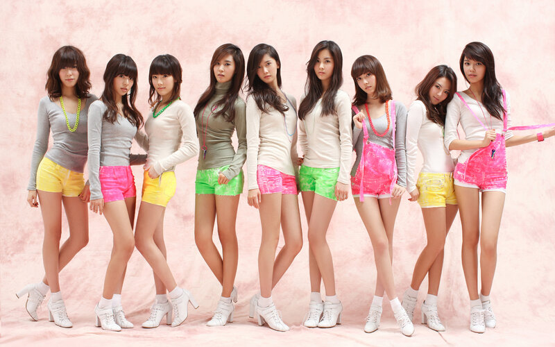 K-pop group in colorful outfits
