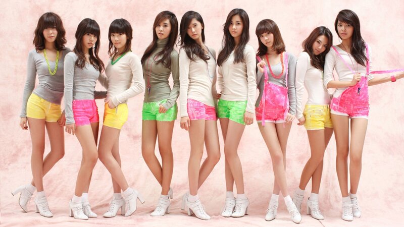 K-pop group in colorful outfits
