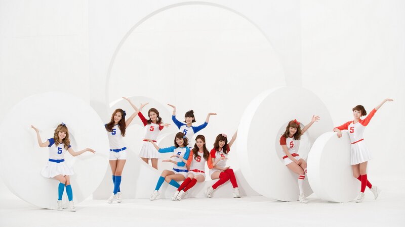 K-pop group in colorful outfits