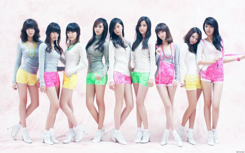 K-pop group in colorful outfits