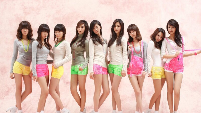 K-pop group in colorful outfits